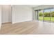 Bright bedroom with wood floors and sliding glass doors leading to the backyard at 5289 Everlong Dr, Apollo Beach, FL 33572
