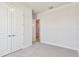 Neutral bedroom with carpet and double closets and a peek into the hallway at 5289 Everlong Dr, Apollo Beach, FL 33572