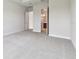 Spacious bedroom with neutral carpet, bathroom and walk-in closet at 5289 Everlong Dr, Apollo Beach, FL 33572