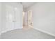 An empty bedroom with white walls and carpet leading to an ensuite bathroom at 5289 Everlong Dr, Apollo Beach, FL 33572