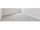 Bedroom with neutral carpet, white baseboards, and a window at 5289 Everlong Dr, Apollo Beach, FL 33572