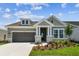 Charming single-Gathering home with a two-car garage and beautifully landscaped front yard at 5289 Everlong Dr, Apollo Beach, FL 33572