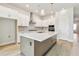 Bright kitchen boasts an island, stainless appliances, and ample cabinet space at 5289 Everlong Dr, Apollo Beach, FL 33572