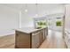 Spacious kitchen features a modern island with seating and plenty of storage at 5289 Everlong Dr, Apollo Beach, FL 33572