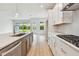 Open-concept kitchen features stainless steel appliances and a large island at 5289 Everlong Dr, Apollo Beach, FL 33572