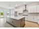 Modern kitchen features a large center island, stainless steel appliances, and wood flooring at 5289 Everlong Dr, Apollo Beach, FL 33572