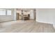 Open-concept living room flows into modern kitchen with white cabinets and stainless steel appliances at 5289 Everlong Dr, Apollo Beach, FL 33572