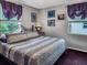 Bedroom with a comfortable bed, soft lighting, and picturesque windows offering ample natural light at 5309 21St S Ave, Gulfport, FL 33707