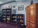 Basement living room showcasing bookshelves and an armoire filled with decorative items at 5309 21St S Ave, Gulfport, FL 33707