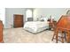 Bright bedroom with carpeted floors, floral bedding, dresser, desk, and chair at 5581 Salem Square S Dr, Palm Harbor, FL 34685