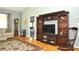 Inviting living room featuring hardwood floors, decorative rug, and custom built-in shelves at 5581 Salem Square S Dr, Palm Harbor, FL 34685
