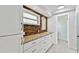 Bathroom features a granite countertop with wood backsplash and pristine white cabinets at 800 Madonna Blvd # 2, Tierra Verde, FL 33715