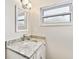 Modern bathroom sink with granite countertop and updated light fixture at 800 Madonna Blvd # 2, Tierra Verde, FL 33715