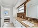 Granite countertops and decorative backsplash enhance the vanity in this bathroom at 800 Madonna Blvd # 2, Tierra Verde, FL 33715
