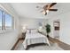 Bedroom with ceiling fan, light walls, and wood floors offers a calming retreat at 800 Madonna Blvd # 2, Tierra Verde, FL 33715