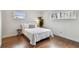 Bright bedroom features wood floors, white walls, and natural light from two windows at 800 Madonna Blvd # 2, Tierra Verde, FL 33715