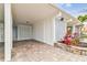 A spacious carport with brick flooring and a decorative block wall, providing ample parking and style at 800 Madonna Blvd # 2, Tierra Verde, FL 33715