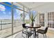 Bright dining area boasts floor-to-ceiling windows with pool and water views at 800 Madonna Blvd # 2, Tierra Verde, FL 33715