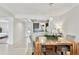 Bright dining room featuring a stylish wooden table, gray chairs, and modern light fixture, open to the kitchen at 800 Madonna Blvd # 2, Tierra Verde, FL 33715