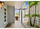 Inviting front entrance featuring tile flooring, a tropical landscaped view, and a welcome mat at 800 Madonna Blvd # 2, Tierra Verde, FL 33715