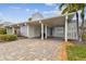 Charming single Gathering home with a two-car carport featuring a stylish brick driveway and unique facade at 800 Madonna Blvd # 2, Tierra Verde, FL 33715