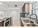 Updated kitchen features granite counters, stainless steel appliances, and breakfast bar at 800 Madonna Blvd # 2, Tierra Verde, FL 33715