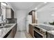 Updated kitchen featuring granite counters, stainless steel appliances, and tile flooring at 800 Madonna Blvd # 2, Tierra Verde, FL 33715