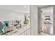 Bright living room with neutral decor, stylish furniture, and tile flooring throughout at 800 Madonna Blvd # 2, Tierra Verde, FL 33715