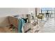 Well-lit living room featuring contemporary furnishings, neutral tones, and an open layout that leads to the balcony at 800 Madonna Blvd # 2, Tierra Verde, FL 33715