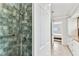 Stylish bathroom shower with tiled walls and safety bars, next to door leading to adjacent room at 800 Madonna Blvd # 2, Tierra Verde, FL 33715