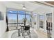 Bright sunroom featuring tile floors, ceiling fan and large windows with a view of the waterfront at 800 Madonna Blvd # 2, Tierra Verde, FL 33715