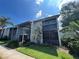 Two-story condo with charming stairs leading to the second floor and a well-manicured lawn at 11201 122Nd Ave # 204, Largo, FL 33778