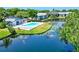 Beautiful community pool surrounded by lush greenery and a serene lake view at 11201 122Nd Ave # 204, Largo, FL 33778