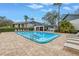 Relaxing poolside view with ample seating under a sunny sky at 11201 122Nd Ave # 204, Largo, FL 33778