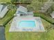 Aerial view of a community pool nestled between lush landscaping and building at 11201 122Nd Ave # 204, Largo, FL 33778