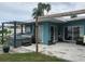 View of the covered patio, jacuzzi, and tropical plants that make the perfect outdoor oasis at 16108 5Th E St, Redington Beach, FL 33708