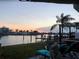 Scenic backyard view, showing waterfront, deck, patio furniture, and an amazing sunset at 16108 5Th E St, Redington Beach, FL 33708