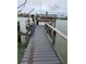 View of the wooden boat dock and boat lift, perfect for enjoying waterfront living at 16108 5Th E St, Redington Beach, FL 33708