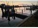 A view of the boat lift on the waterfront property at sunset at 16108 5Th E St, Redington Beach, FL 33708