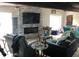 Comfortable living room featuring a stone fireplace, television, and a blue recliner and sofa at 16108 5Th E St, Redington Beach, FL 33708