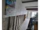 Dilapidated living room with gray beams, a painting of palm trees, and damaged walls at 16108 5Th E St, Redington Beach, FL 33708