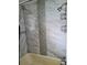 This bathroom features a tile shower with a vertical strip of decorative accent mosaic tiles at 16108 5Th E St, Redington Beach, FL 33708