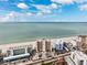 Beautiful beachside condos with direct access to the ocean and pristine, sandy beach under a partially cloudy blue sky at 19450 Gulf Blvd # 401, Indian Shores, FL 33785