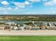 Expansive aerial view of beachfront condos along the Gulf Coast, showcasing the coastline, waterways, and lush landscapes at 19450 Gulf Blvd # 401, Indian Shores, FL 33785
