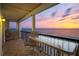 Spacious outdoor balcony featuring comfortable seating with a breathtaking sunset view at 19450 Gulf Blvd # 401, Indian Shores, FL 33785