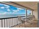 Relax on the spacious balcony overlooking the beach, complete with tile flooring and patio furniture at 19450 Gulf Blvd # 401, Indian Shores, FL 33785