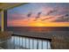 Enjoy breathtaking sunset views from this beachfront balcony, furnished with a dining table at 19450 Gulf Blvd # 401, Indian Shores, FL 33785