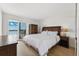 Cozy bedroom with balcony access showcasing stunning ocean views and natural light at 19450 Gulf Blvd # 401, Indian Shores, FL 33785