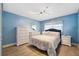 Comfortable blue bedroom with queen bed, dressers, and serene ambiance at 19450 Gulf Blvd # 401, Indian Shores, FL 33785