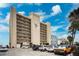 Stunning condominium complex offering beach access, parking, and beautiful views under a partly cloudy blue sky at 19450 Gulf Blvd # 401, Indian Shores, FL 33785